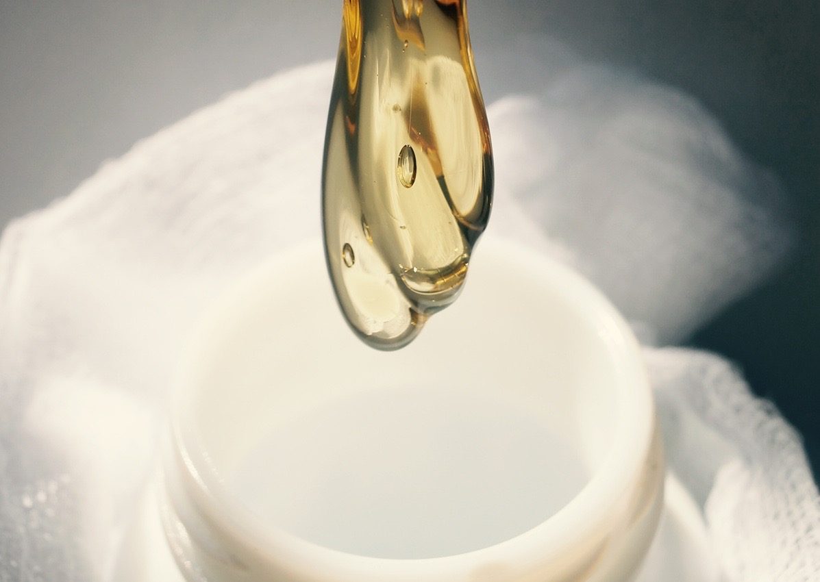 THC distillate pouring into a white silicone jar